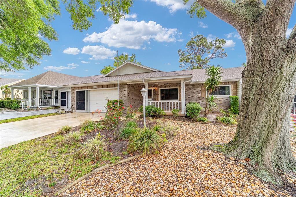 9240 Southwest 90th Court, Unit B Ocala, FL 34481 - Photo 6 of 40 a front view of a house with a garden