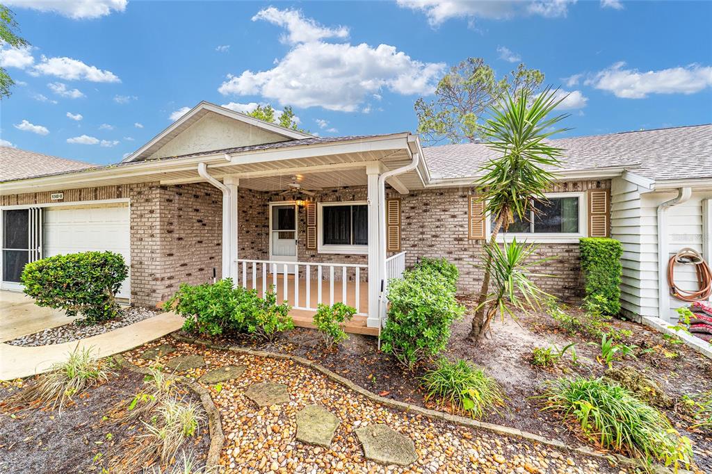 9240 Southwest 90th Court, Unit B Ocala, FL 34481 - Photo 7 of 40 a front view of a house with garden