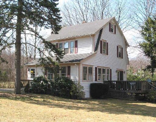 12 Sunset Pass Wilton, CT 06897 - Photo 1 of 1 a front view of a house with a yard