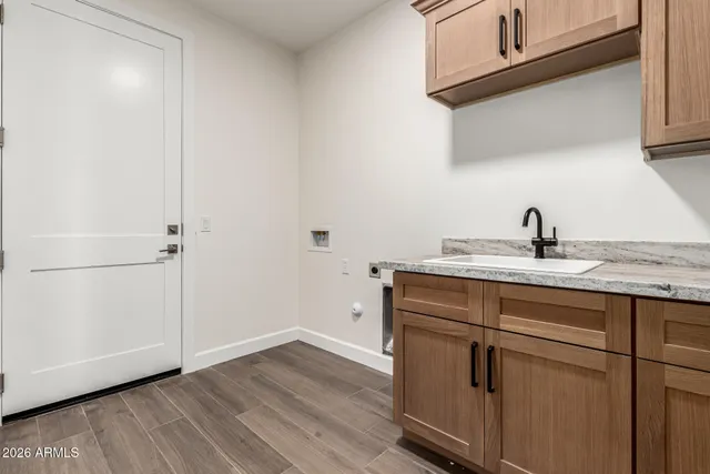 a view of a sink and dishwasher with wooden floor