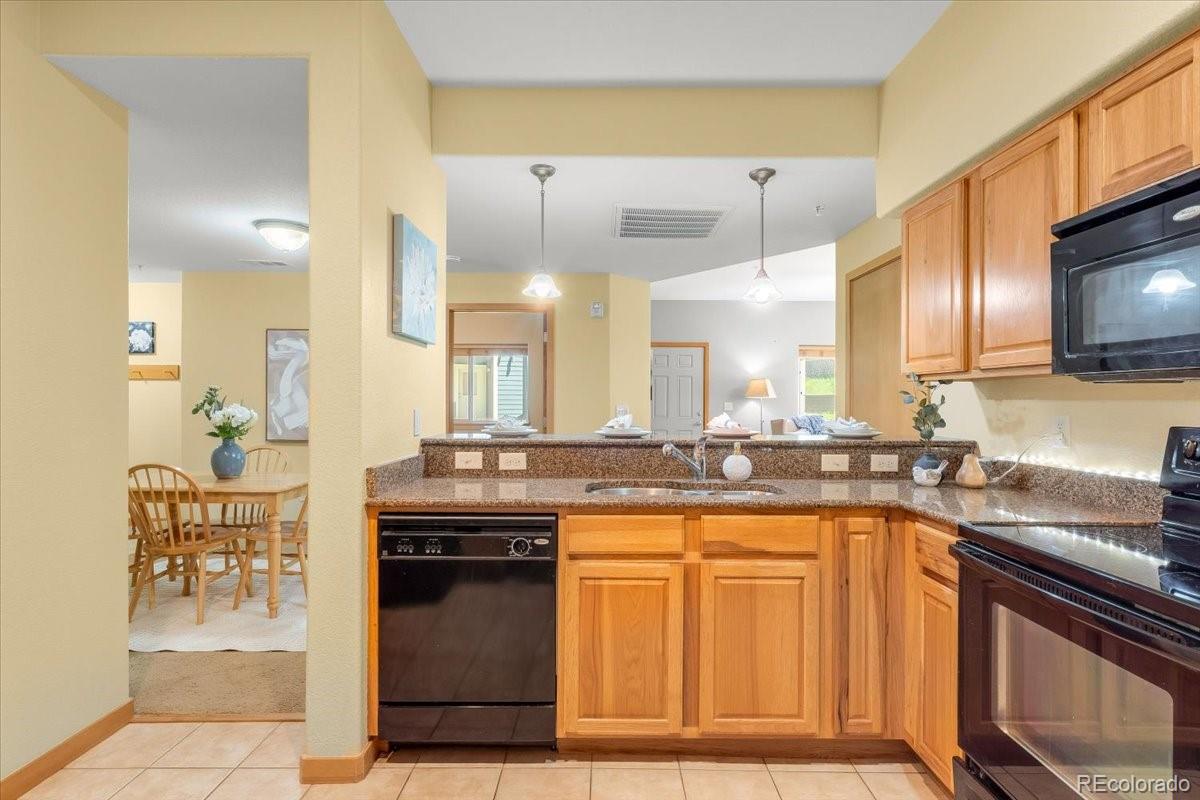 140 Sterling Loop, Unit 202 Fraser, CO 80442 - Photo 13 of 24 a kitchen with granite countertop a sink and cabinets