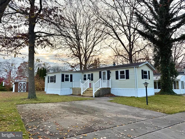 a view of a house with a yard covered in it
