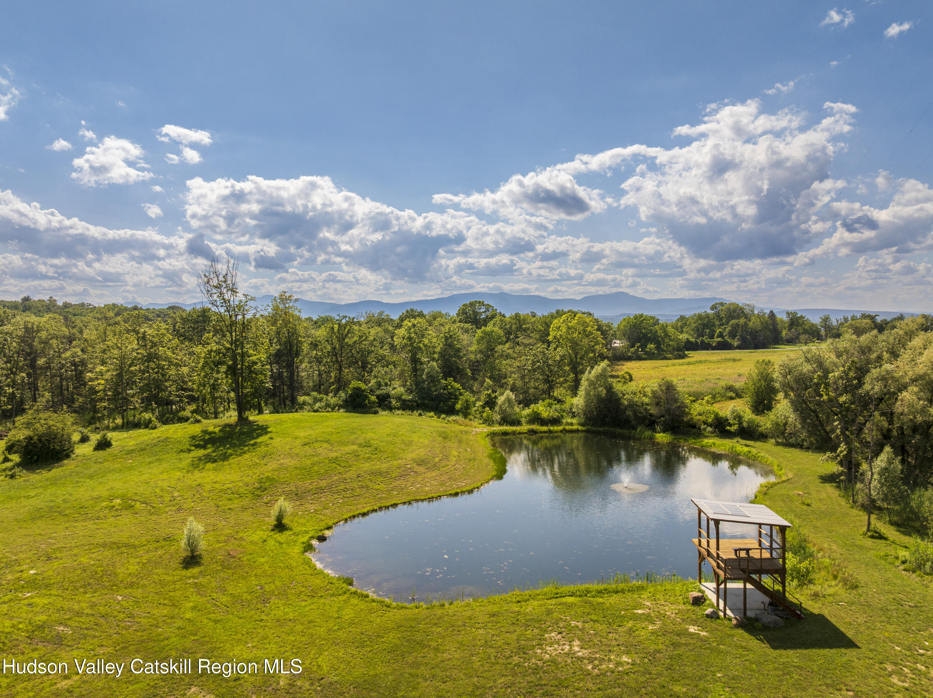 48 County Rte 14 Hudson, NY 12534 - Photo 39 of 42 a view of a lake with lawn chairs