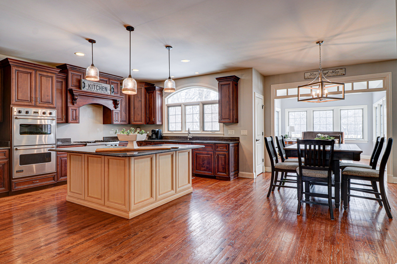 N491 Peter Road Winfield, IL 60190 - Photo 16 of 46 a kitchen with stainless steel appliances granite countertop wooden floors stove and a center island