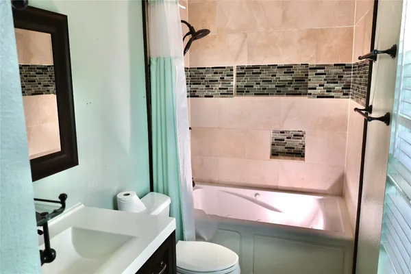 a bathroom with a sink toilet and mirror