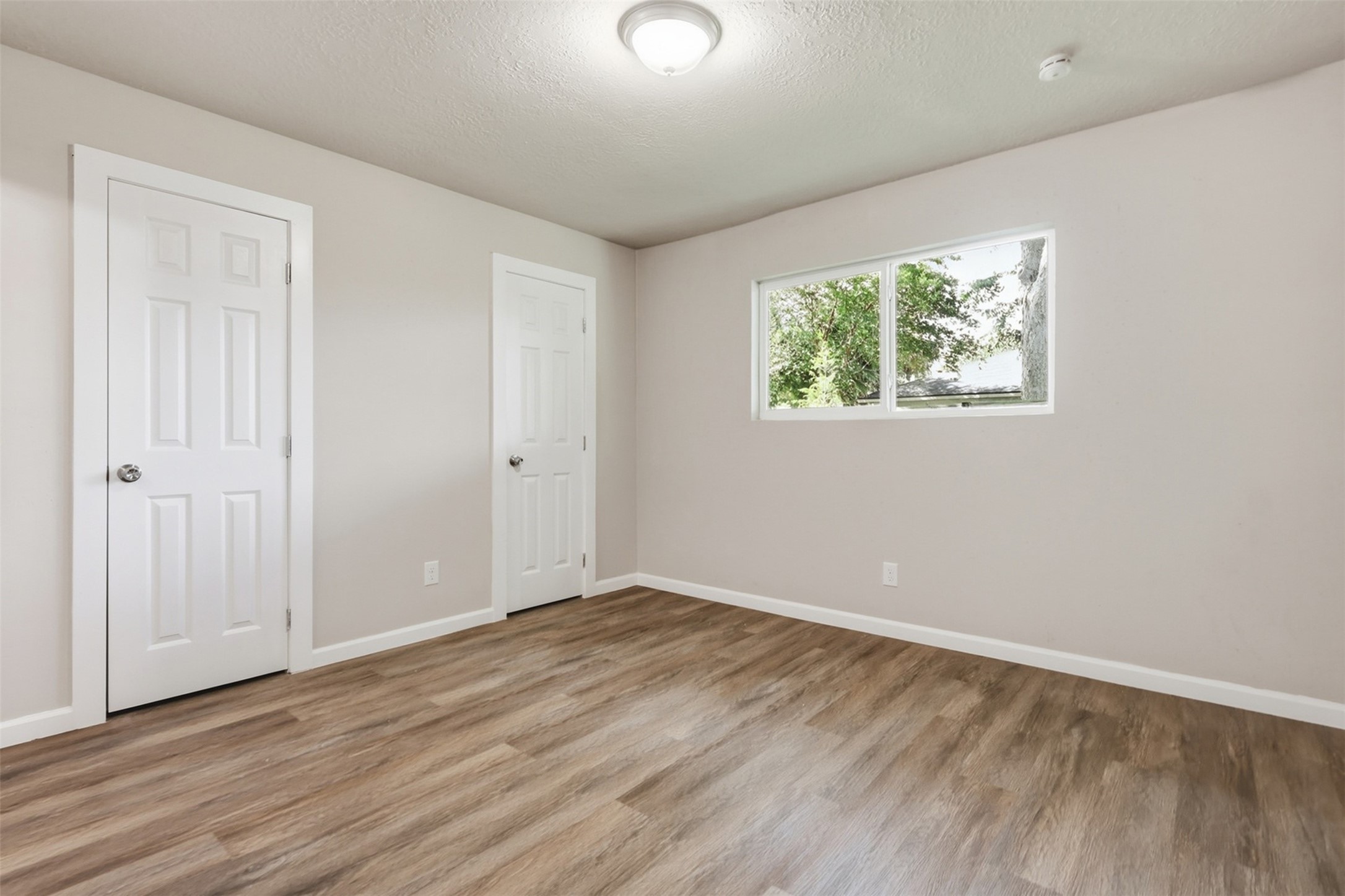 4767 Beechaven Street Houston, TX 77053 - Photo 16 of 26 an empty room with wooden floor and windows