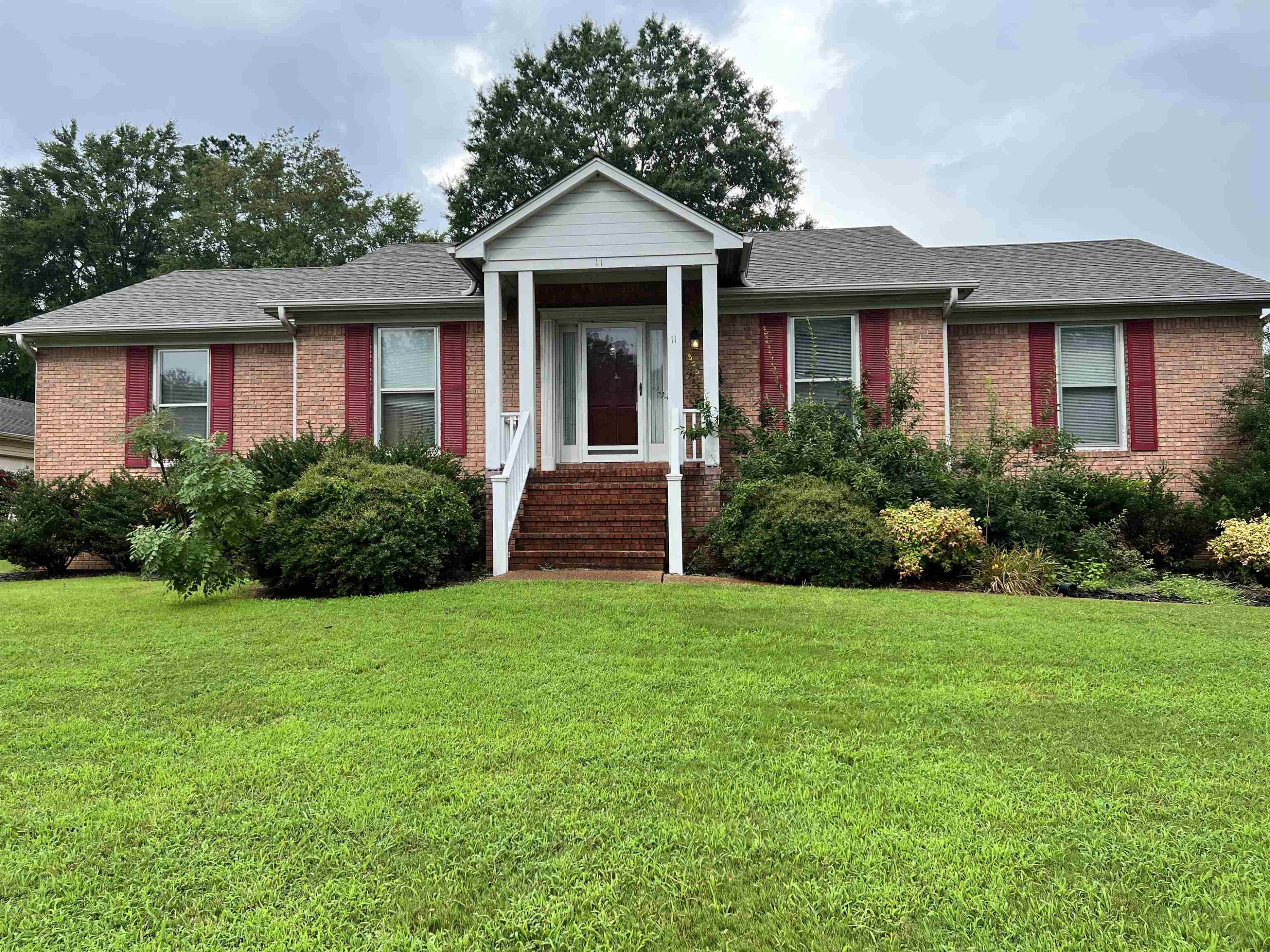 11 Yorkshire Cove Jackson, TN 38305 - Photo 1 of 7 a front view of a house with garden