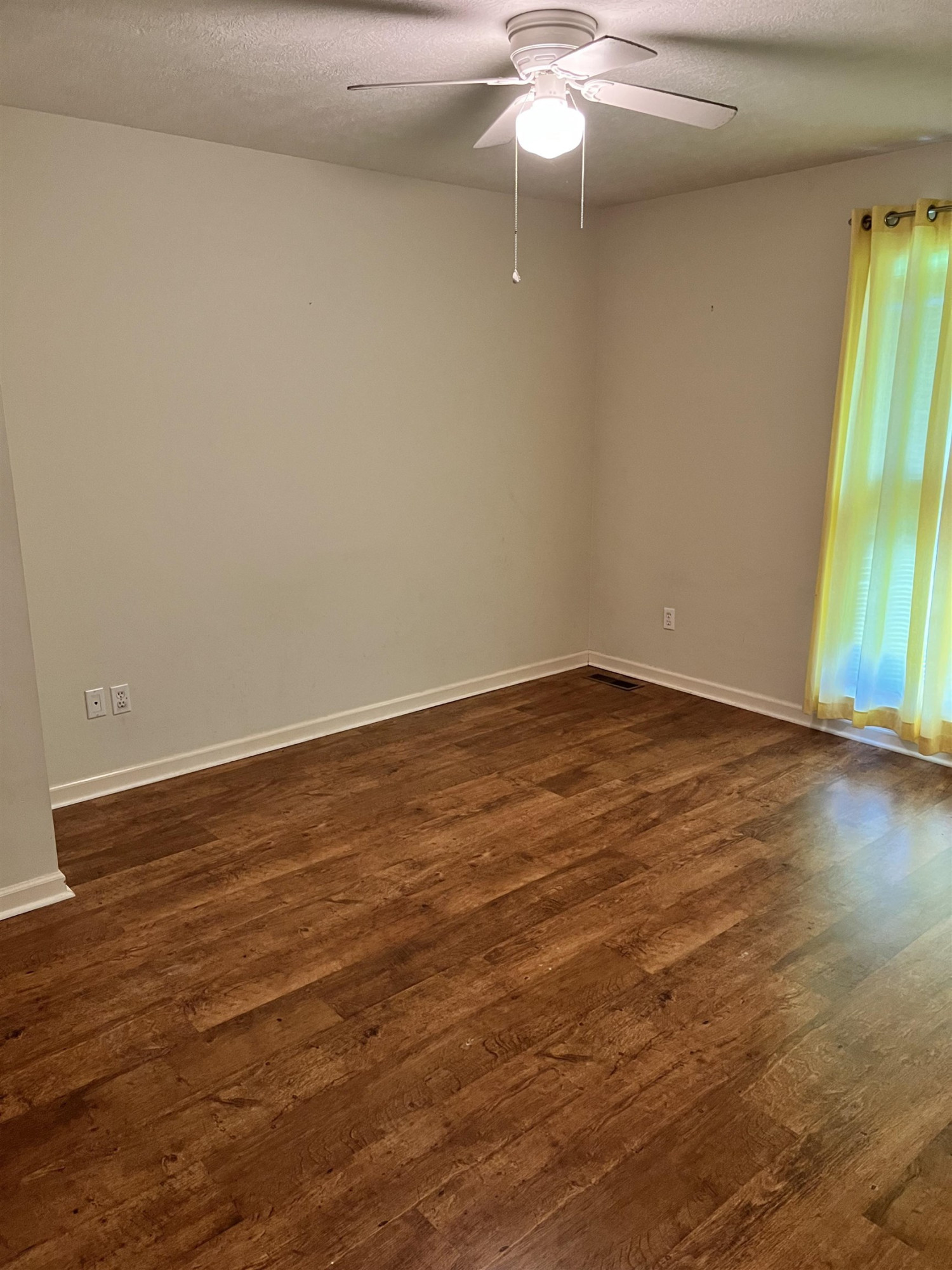 11 Yorkshire Cove Jackson, TN 38305 - Photo 6 of 7 an empty room with wooden floor fan and windows