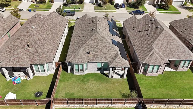 an aerial view of multiple houses with yard