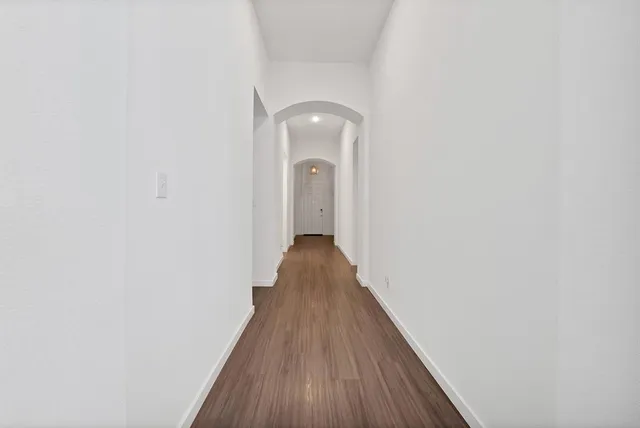 a view of a room with wooden floor and white walls