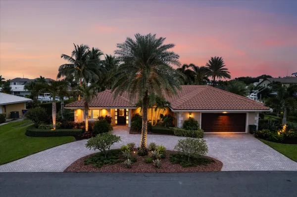 a front view of a house with a yard and a garage