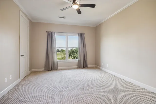 a view of a livingroom with a ceiling fan and window