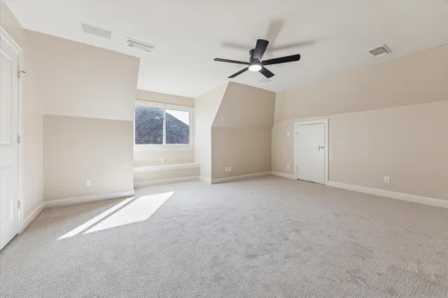 a view of a big room with closet and windows