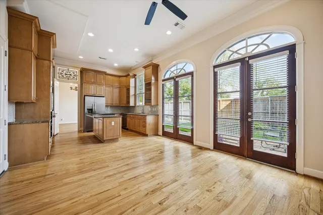 a view of kitchen with stainless steel appliances granite countertop a refrigerator and wooden floor