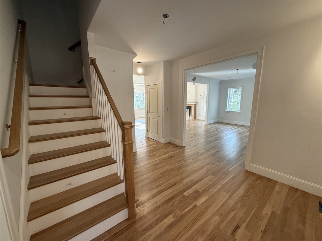 120 Maple Street Stow, MA 01775 - Photo 19 of 36 a view of a hallway with wooden floor and entryway