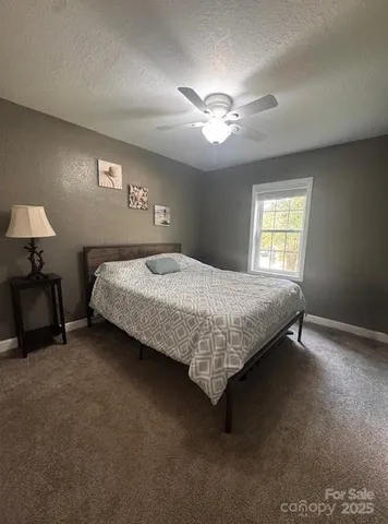 a bedroom with a bed and a lamp