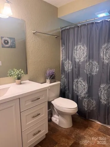 a bathroom with a toilet sink and shower