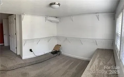 a view of a closet with wooden floor