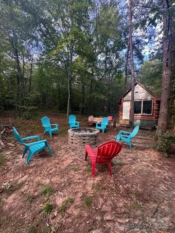 a garden with wooden fence and trees