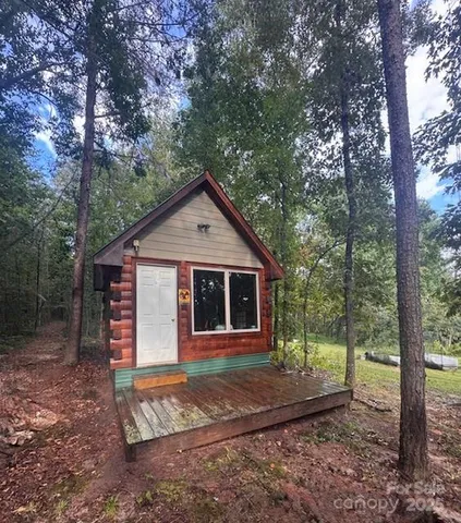 a front view of a house with a yard and trees