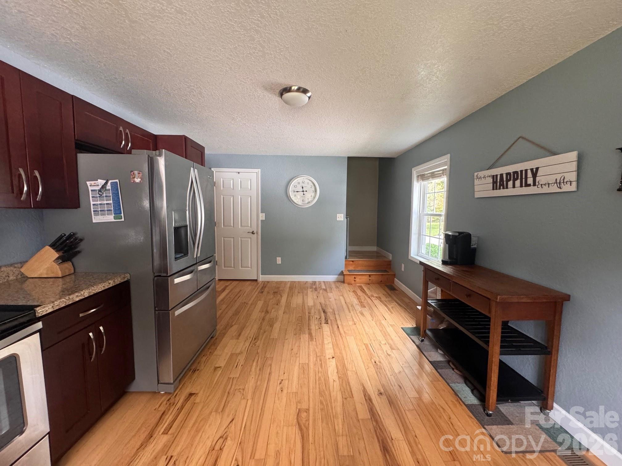 641 Camp Creek Road Union Mills, NC 28167 - Photo 28 of 29 a kitchen with granite countertop a refrigerator a stove and wooden floor