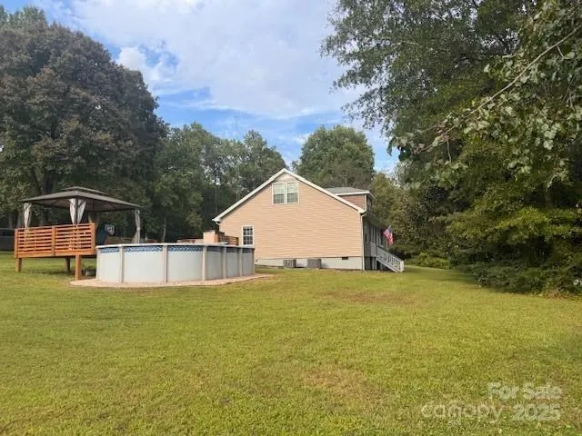 a view of a swimming pool with a house in the background