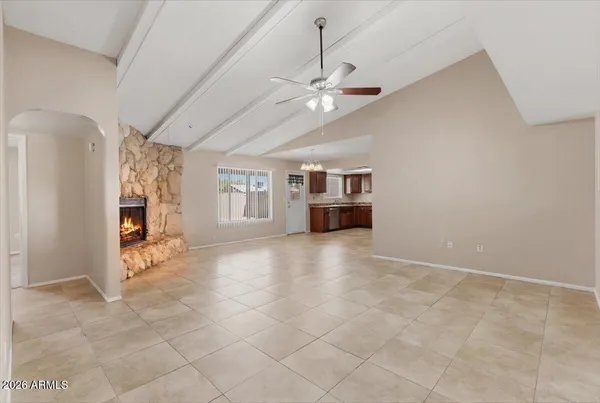 an empty room with fireplace and windows