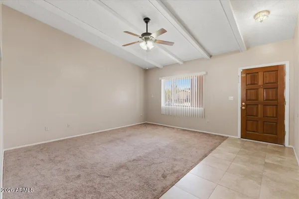 an empty room with fan and windows