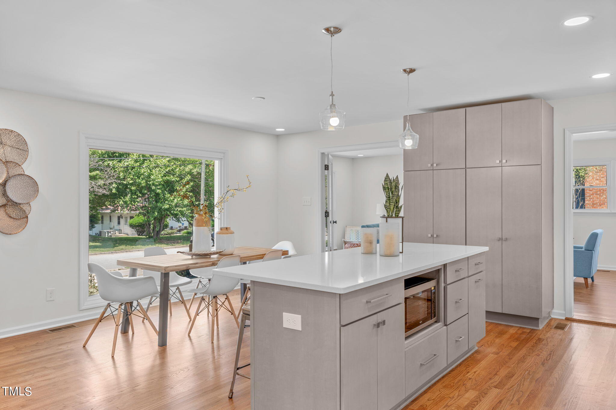 612 Delany Drive Raleigh, NC 27610 - Photo 12 of 45 a kitchen with a sink a stove a dining table and chairs