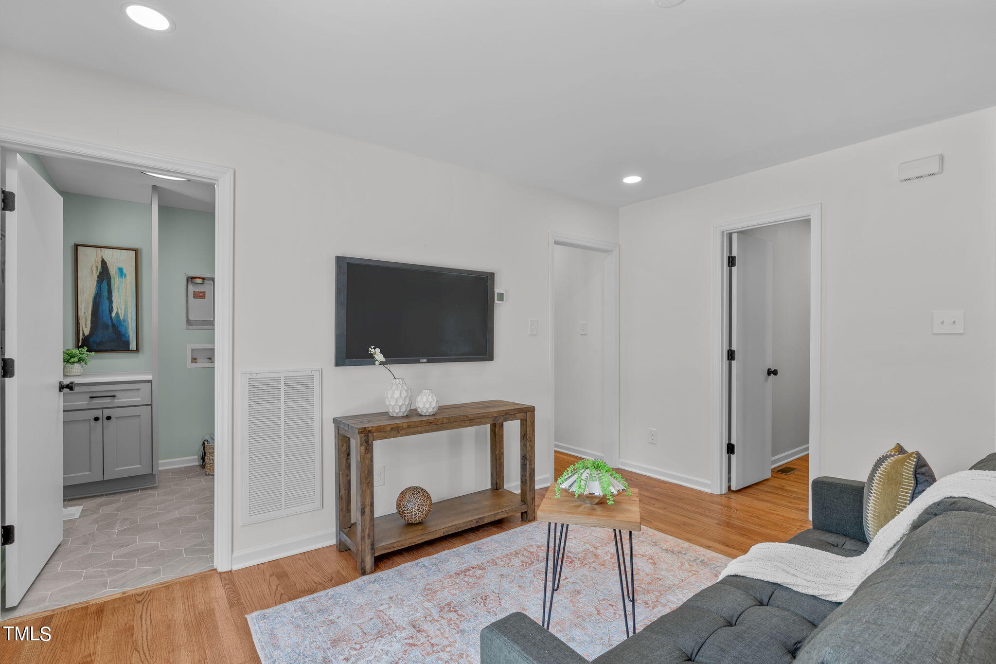 612 Delany Drive Raleigh, NC 27610 - Photo 17 of 45 a living room with furniture a flat screen tv and a fireplace