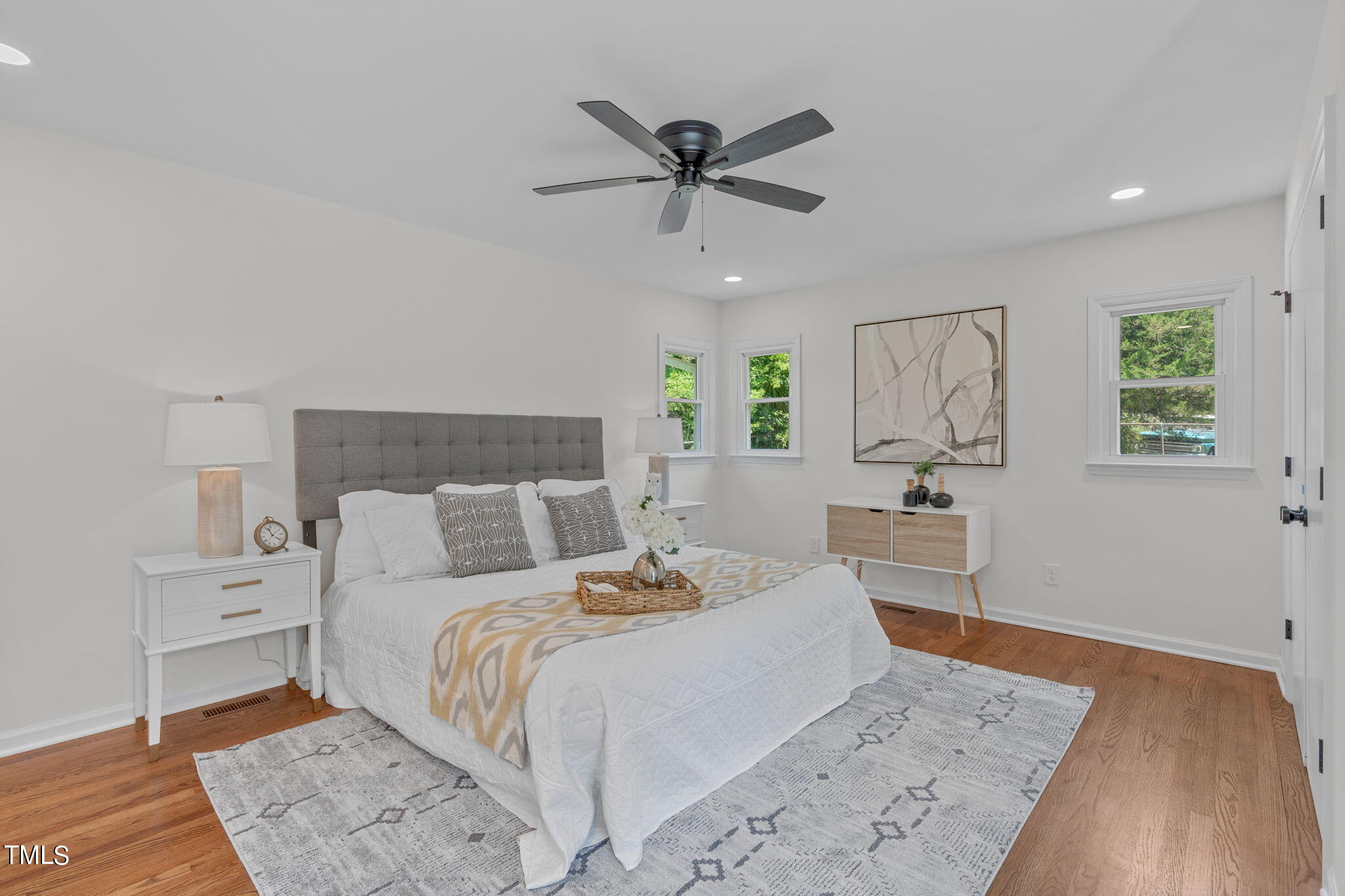 612 Delany Drive Raleigh, NC 27610 - Photo 28 of 45 a bedroom with a large bed and a chandelier