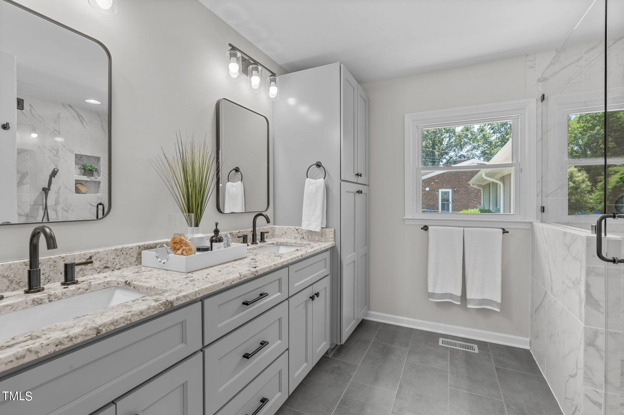 612 Delany Drive Raleigh, NC 27610 - Photo 30 of 45 a bathroom with double sink and a mirror