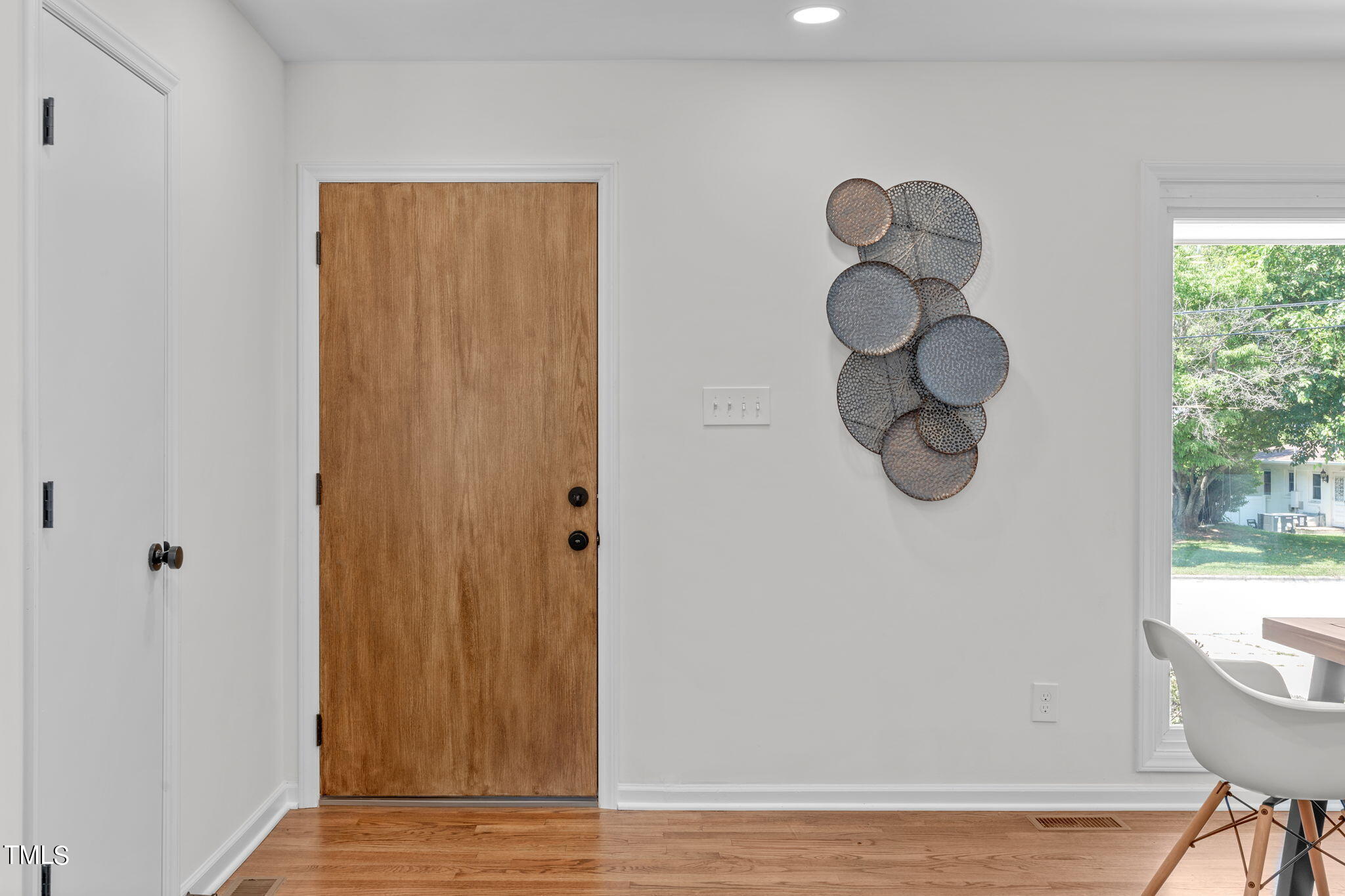 612 Delany Drive Raleigh, NC 27610 - Photo 3 of 45 a view of a hallway with entryway wooden floor and door