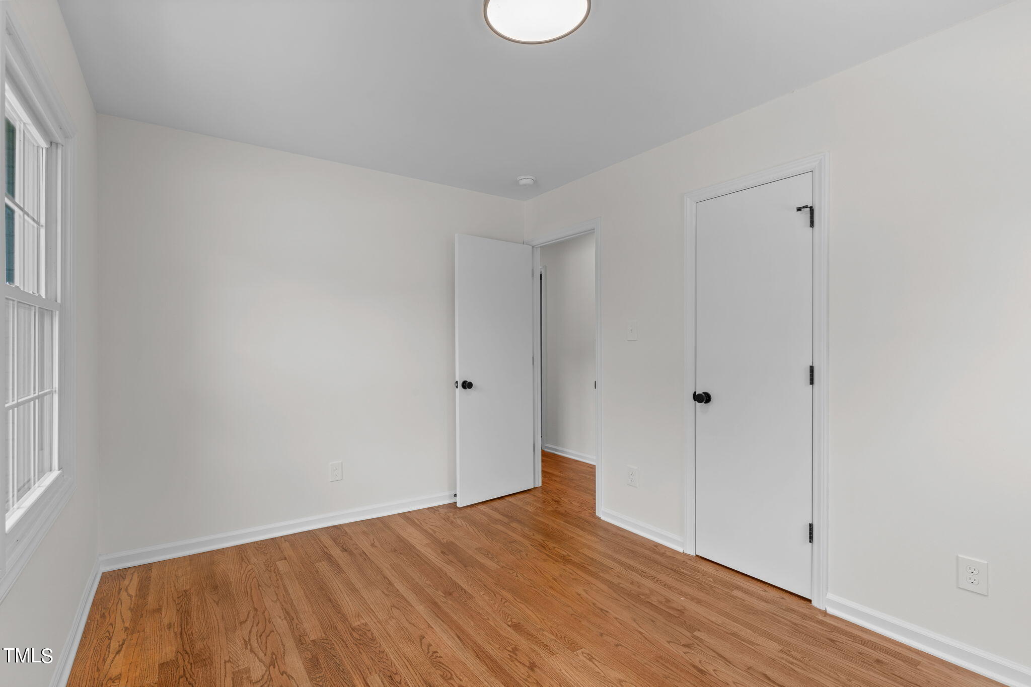 612 Delany Drive Raleigh, NC 27610 - Photo 36 of 45 a view of empty room with wooden floor