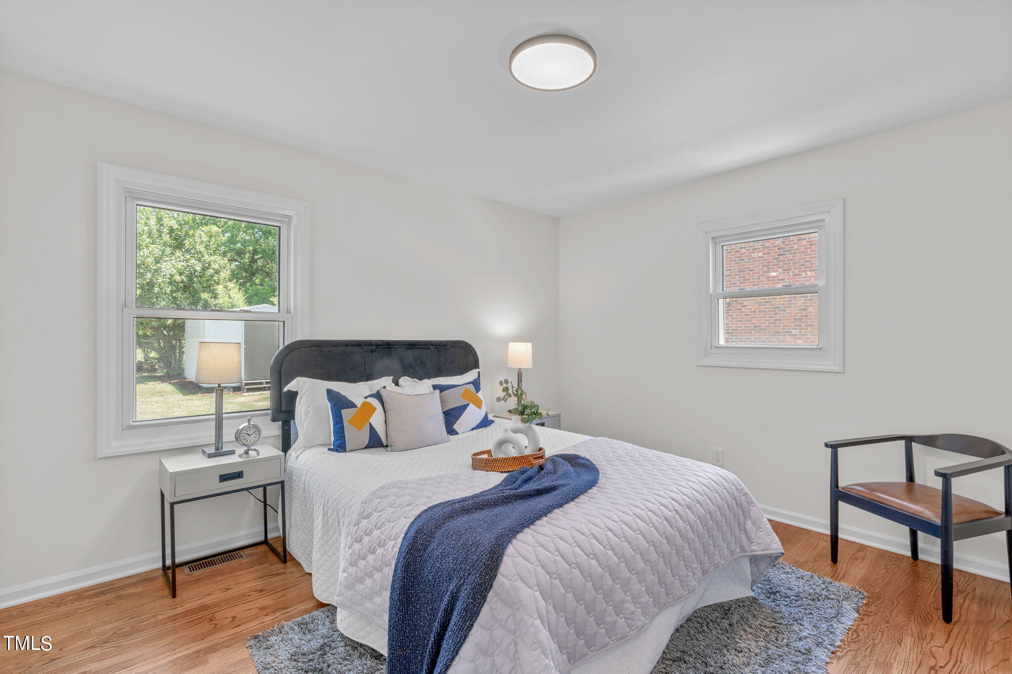 612 Delany Drive Raleigh, NC 27610 - Photo 37 of 45 a bedroom with a bed and wooden floor