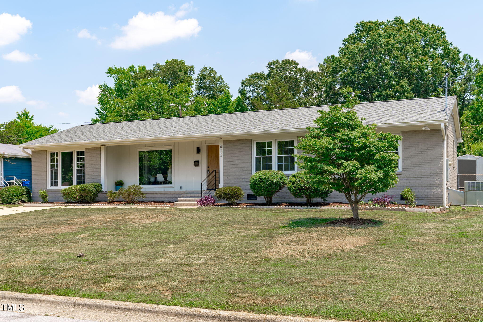 612 Delany Drive Raleigh, NC 27610 - Photo 45 of 45 a front view of a house with a yard and potted plants