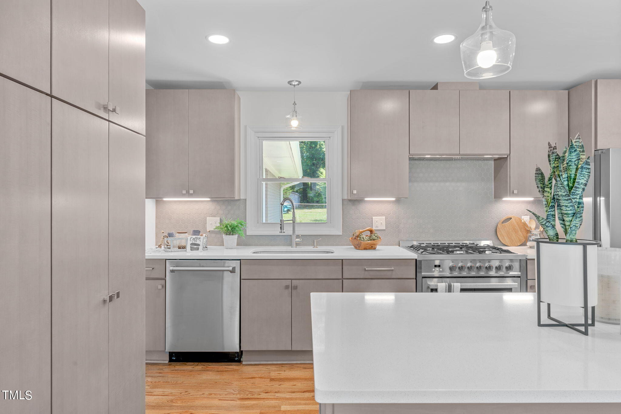 612 Delany Drive Raleigh, NC 27610 - Photo 9 of 45 a kitchen with kitchen island stainless steel appliances a sink a stove a refrigerator and cabinets