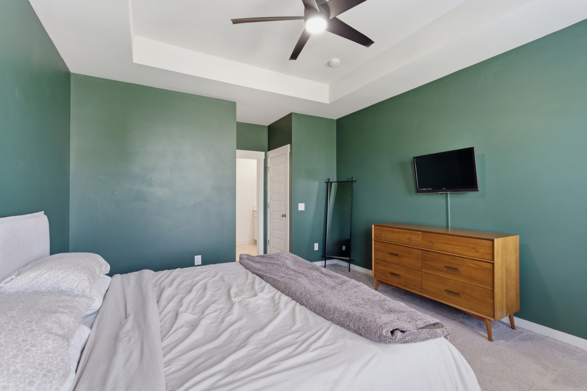 165 Harvest Point Boulevard Spring Hill, TN 37174 - Photo 14 of 28 a bedroom with a bed and a flat screen tv