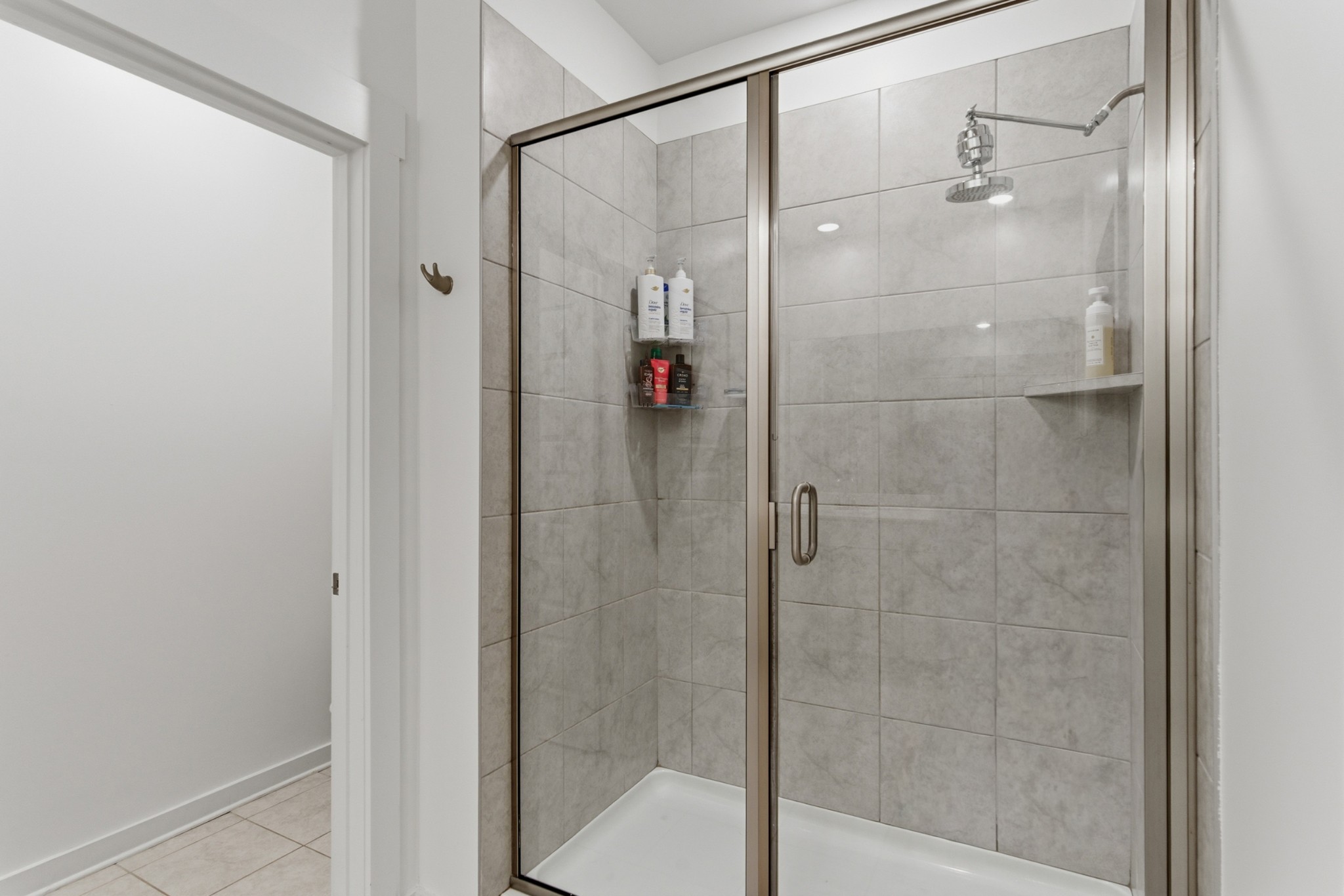 165 Harvest Point Boulevard Spring Hill, TN 37174 - Photo 16 of 28 a bathroom with a glass shower door