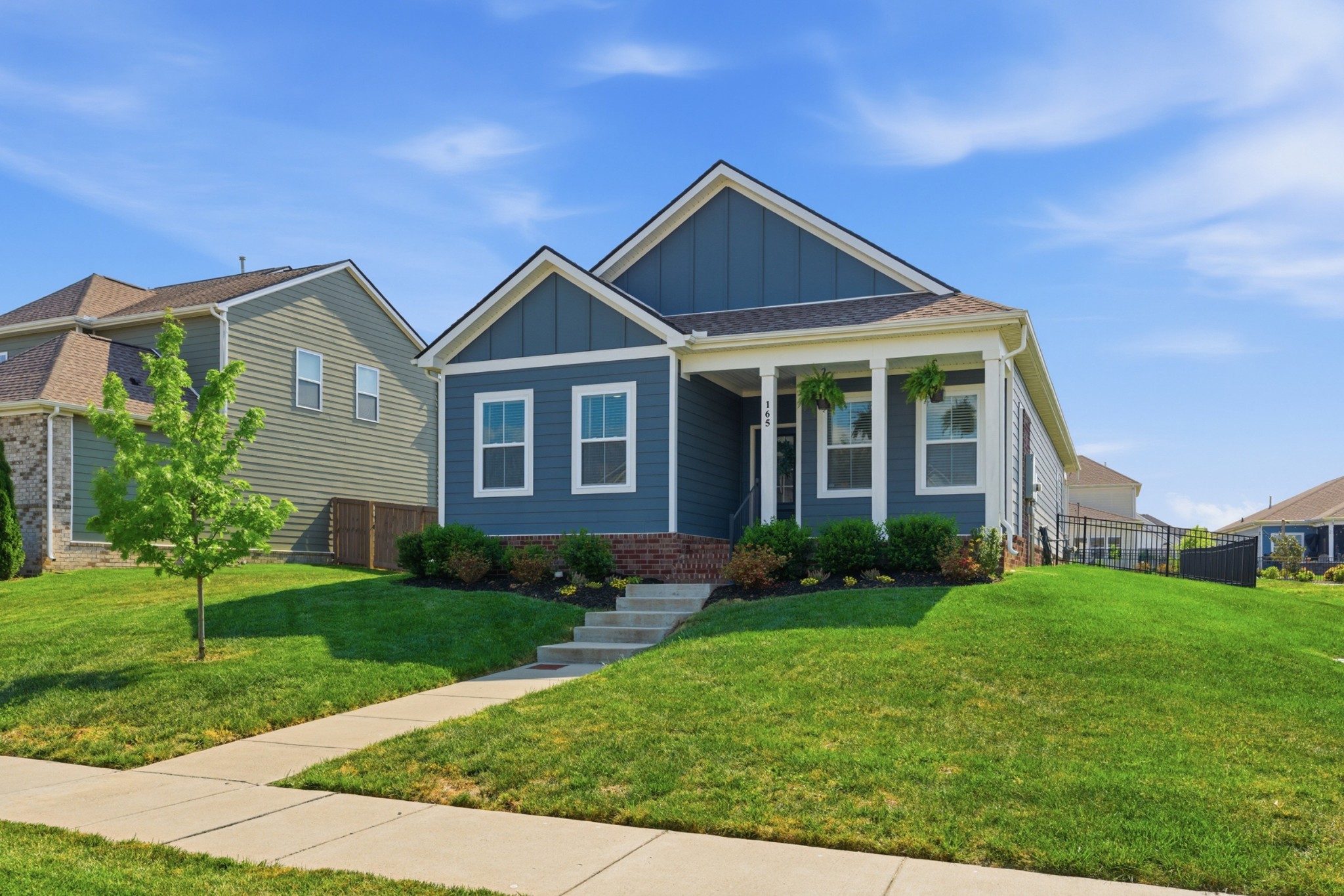 165 Harvest Point Boulevard Spring Hill, TN 37174 - Photo 2 of 28 a front view of a house with garden