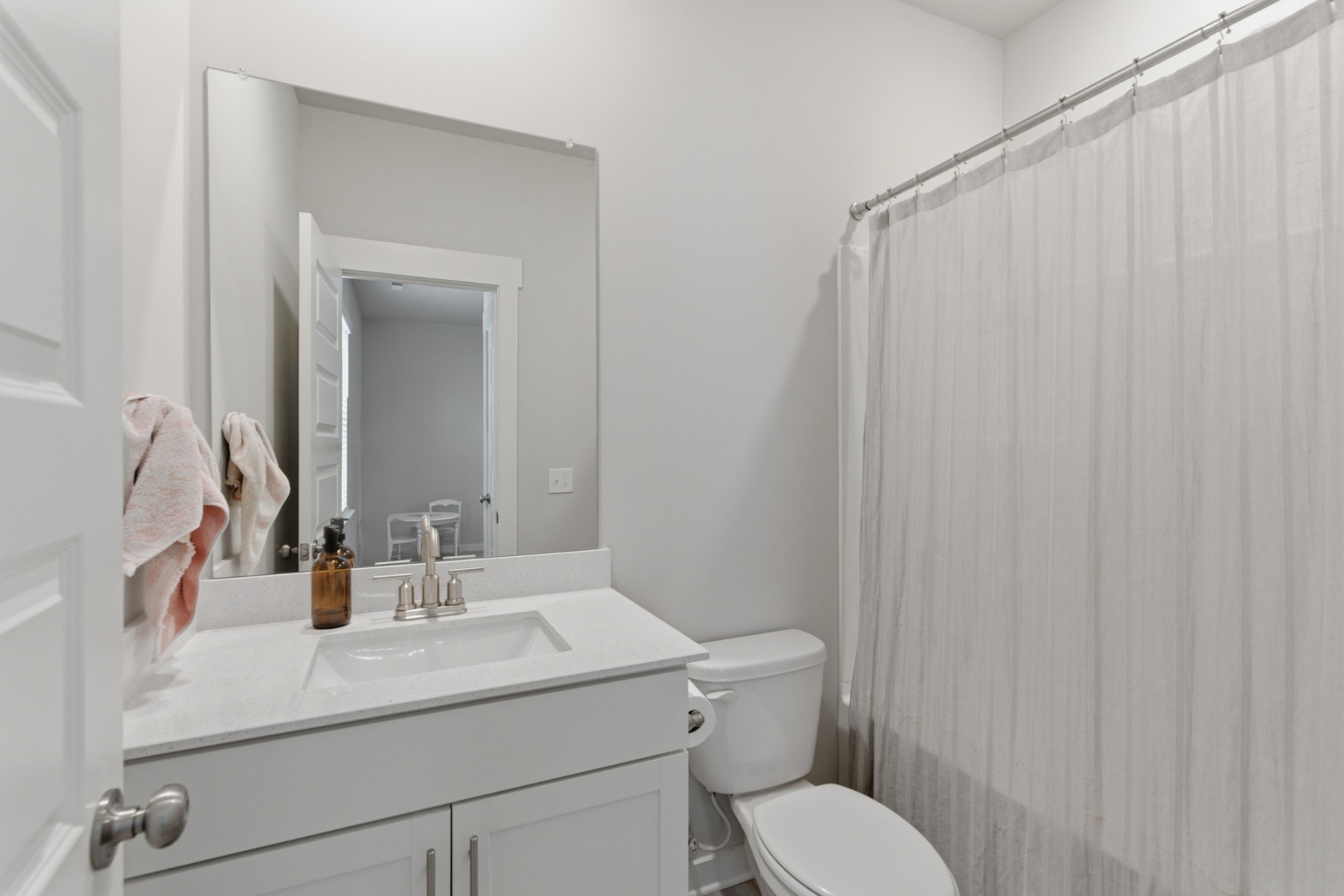 165 Harvest Point Boulevard Spring Hill, TN 37174 - Photo 22 of 28 a bathroom with a sink a toilet and shower curtain