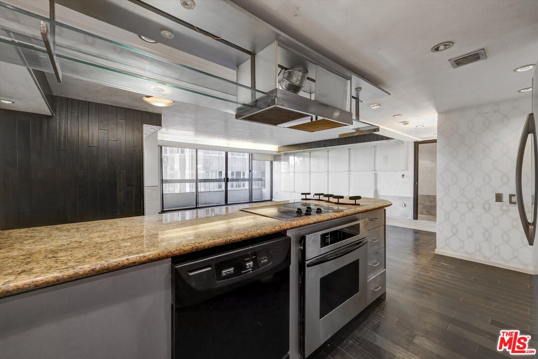 10590 Wilshire Boulevard, Unit 504 Los Angeles, CA 90024 - Photo 11 of 53 a kitchen with stainless steel appliances granite countertop a stove and a refrigerator