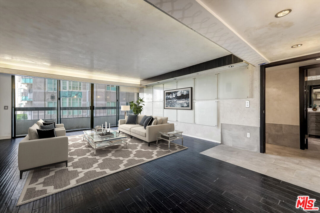 10590 Wilshire Boulevard, Unit 504 Los Angeles, CA 90024 - Photo 13 of 53 a living room with furniture and a floor to ceiling window