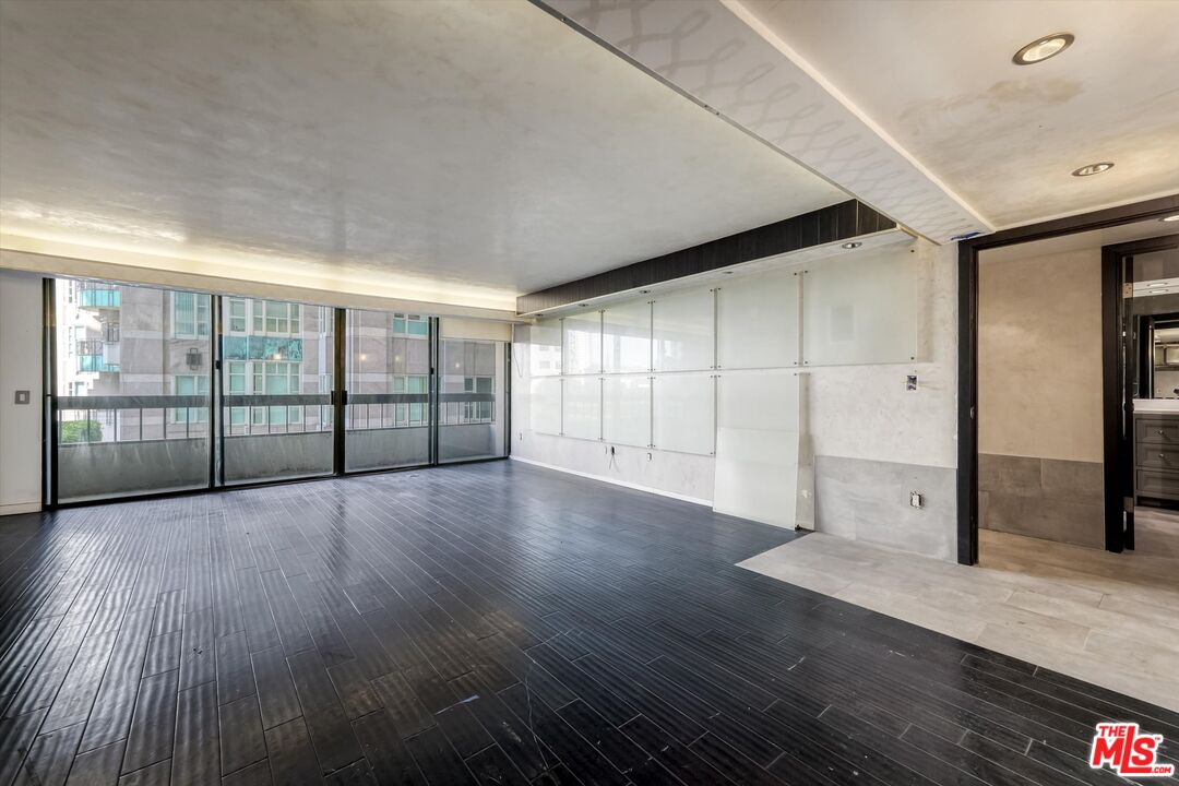 10590 Wilshire Boulevard, Unit 504 Los Angeles, CA 90024 - Photo 14 of 53 an empty room with wooden floor and windows