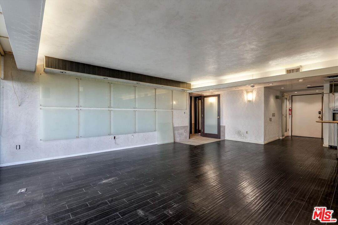 10590 Wilshire Boulevard, Unit 504 Los Angeles, CA 90024 - Photo 19 of 53 an empty room with wooden floor and windows
