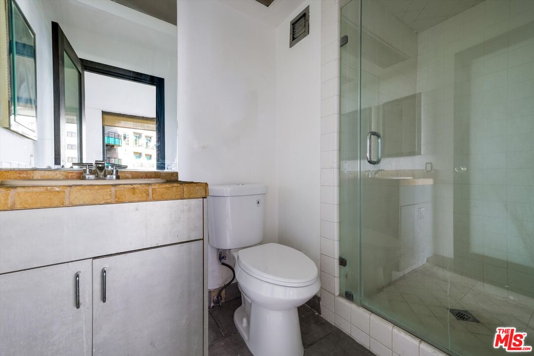 10590 Wilshire Boulevard, Unit 504 Los Angeles, CA 90024 - Photo 30 of 53 a bathroom with a sink a toilet and shower