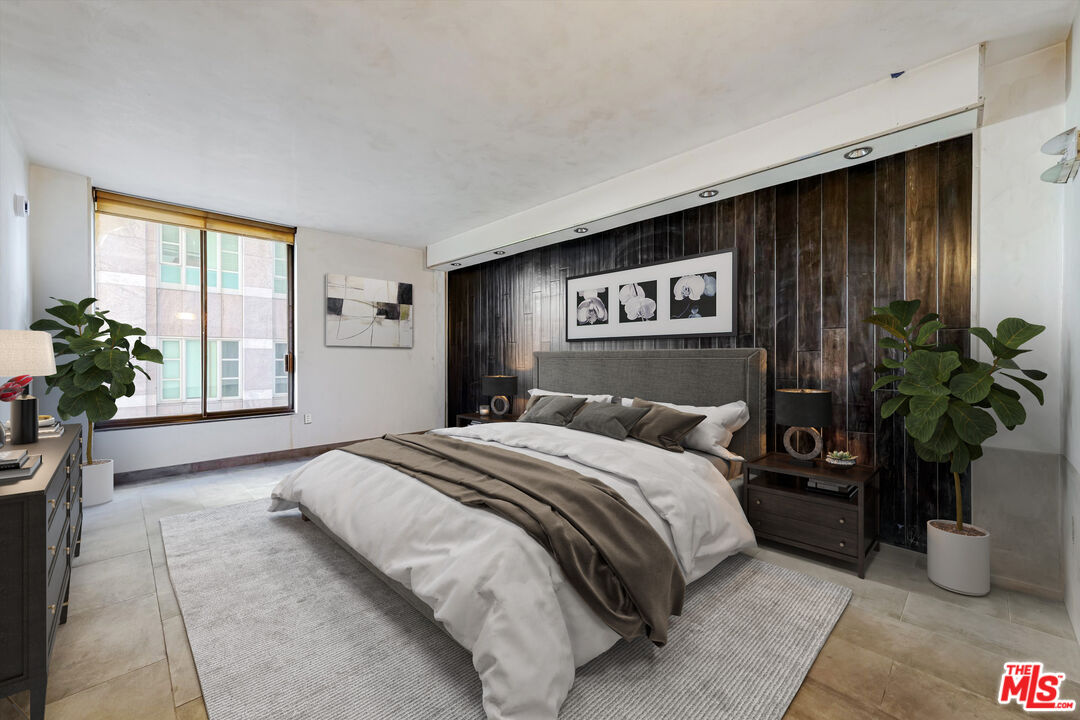 10590 Wilshire Boulevard, Unit 504 Los Angeles, CA 90024 - Photo 31 of 53 a bedroom with a large bed and a potted plant