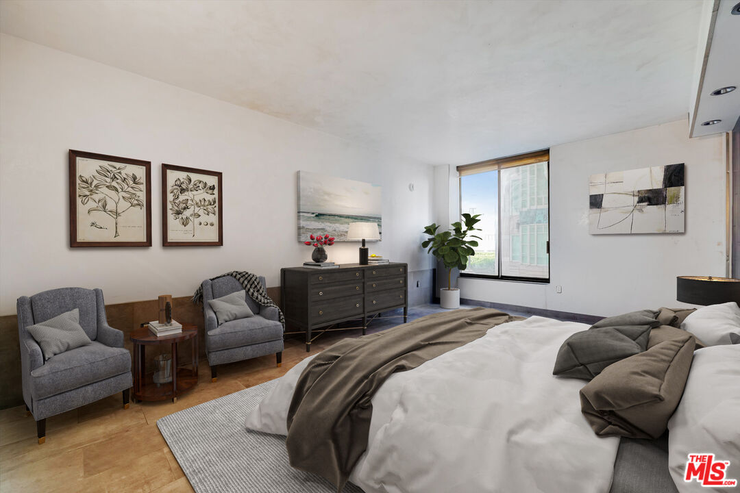 10590 Wilshire Boulevard, Unit 504 Los Angeles, CA 90024 - Photo 33 of 53 a bedroom with a bed couch and a window