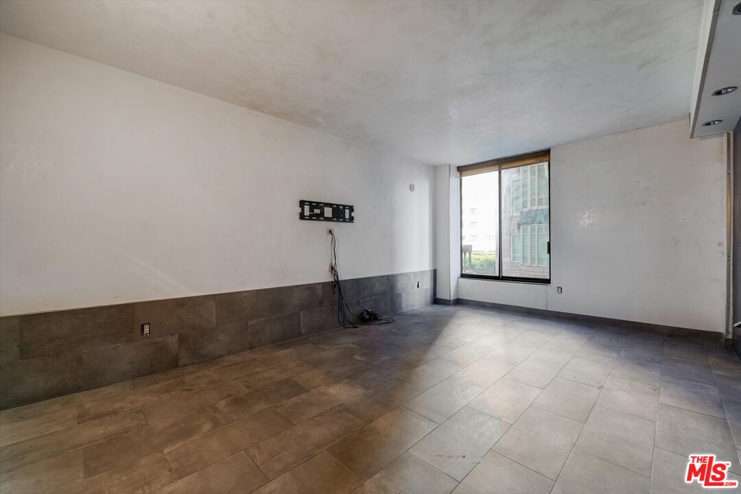 10590 Wilshire Boulevard, Unit 504 Los Angeles, CA 90024 - Photo 34 of 53 an empty room with windows