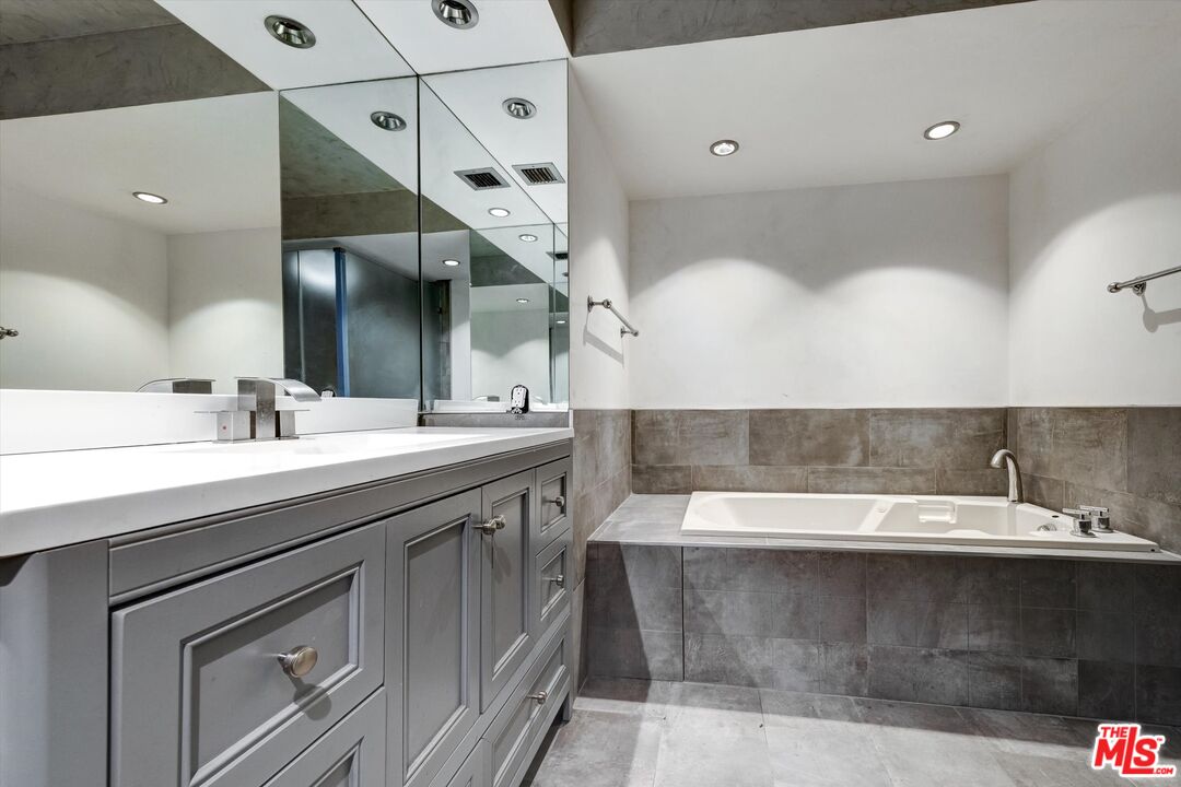 10590 Wilshire Boulevard, Unit 504 Los Angeles, CA 90024 - Photo 38 of 53 a bathroom with a sink and a mirror